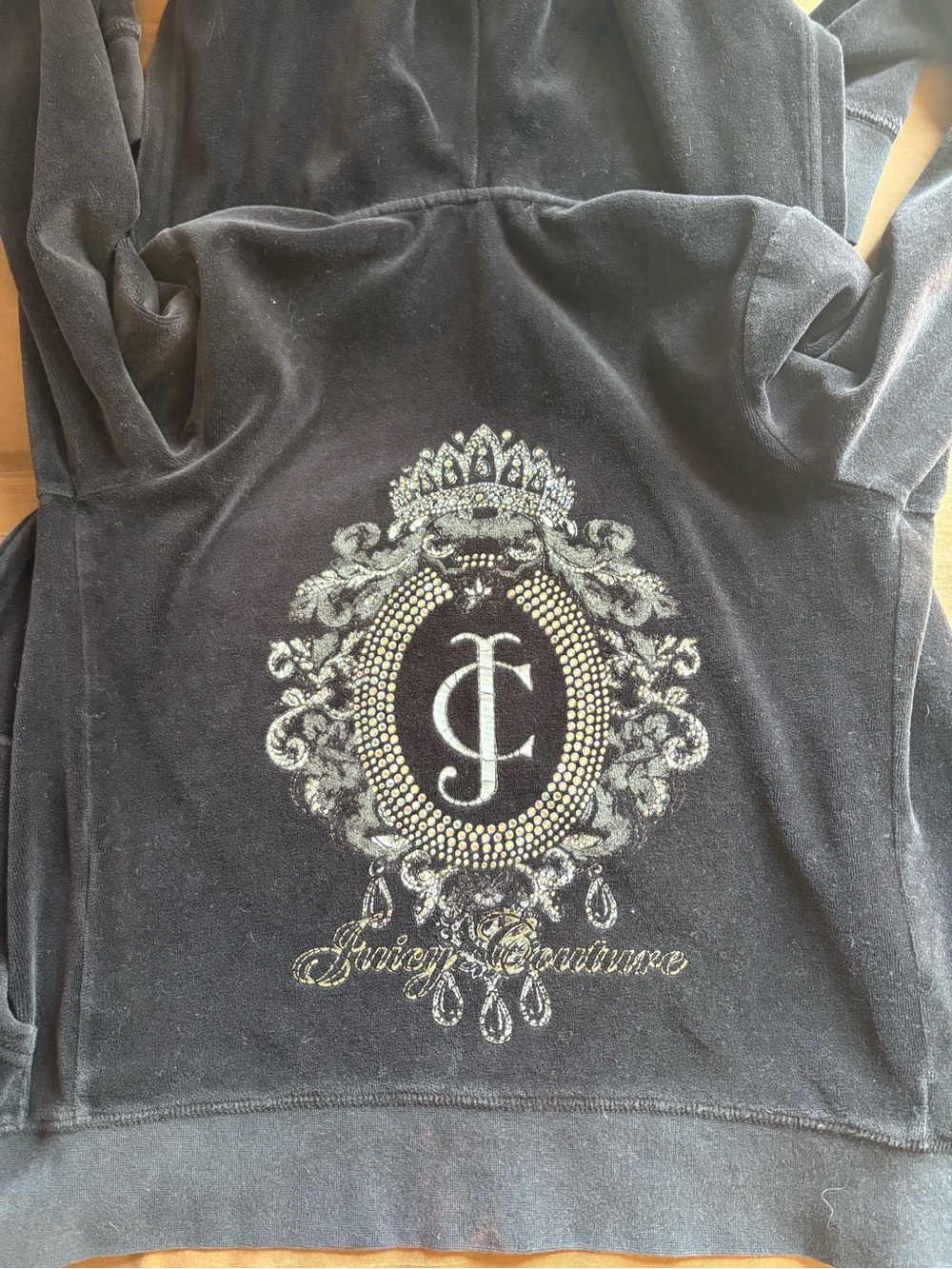 Juicy Couture and features a large, ornate embellished logo